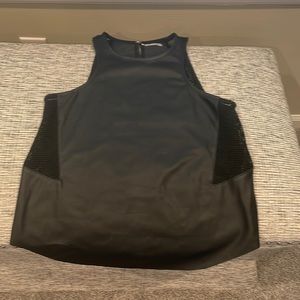 Tobi black faux leather tank. Netting in the sides. Clip closure in the back.
